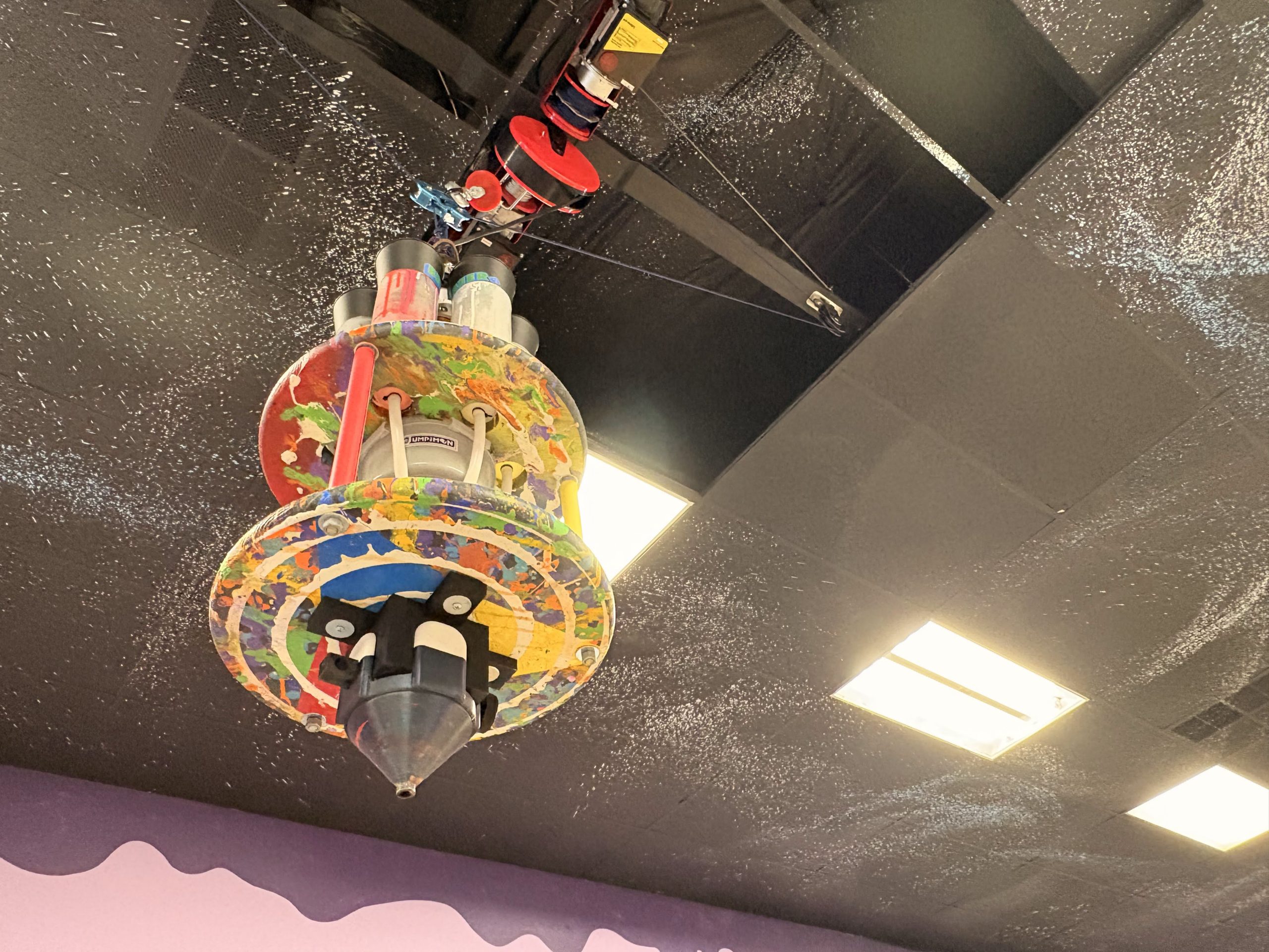 A remote controlled pendulum filled with different colors of paint allows patrons with limited mobility to create larger-scale art projects at Jump The Moon. 